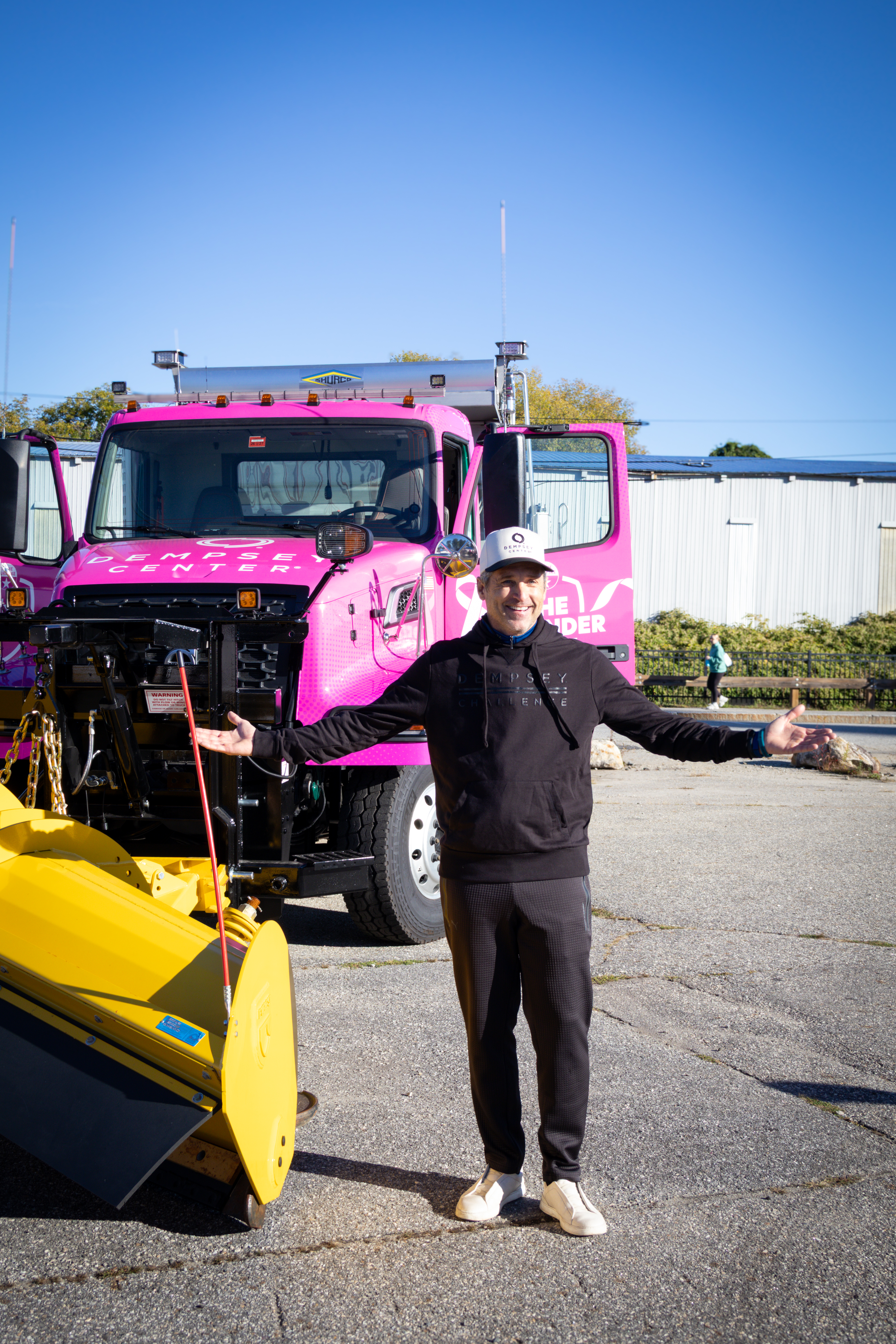 Actor Patrick Dempsey in front of The Defender snow plow named in his honor