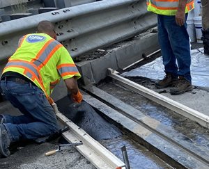 A-contractor-repairs-a-concrete-header-on-a-bridge-in-August-2024.jpg