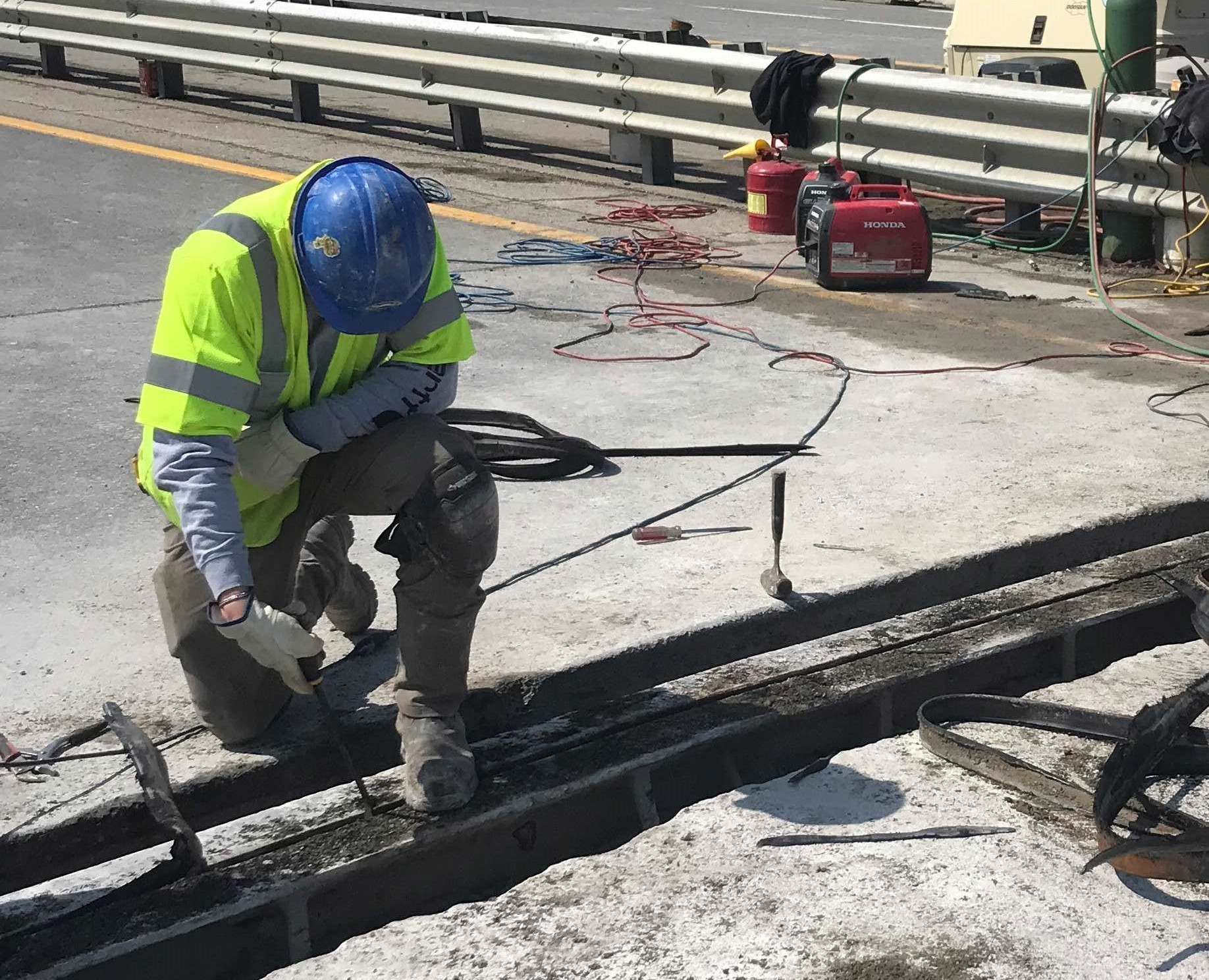 A-worker-removes-old-portions-of-a-bridge-in-April-2025.jpg A-worker-removes-old-portions-of-a-bridge-in-April-2025.jpg